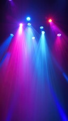 Colorful stage lighting beams in a dark venue.