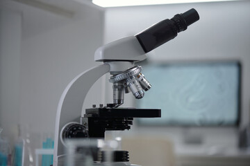 Close-up of advanced microscope in laboratory environment focusing on detailed examination of scientific samples showcasing sleek design and modern technology in research setting