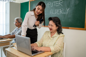 Asian female instructor teaching mature students in classroom at school. 