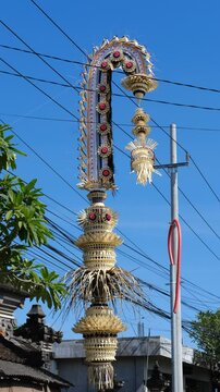Traditional Balinese Penjor with Blue Sky Background