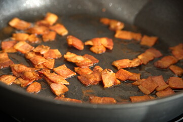 High angle view of frying bacon in frying pan