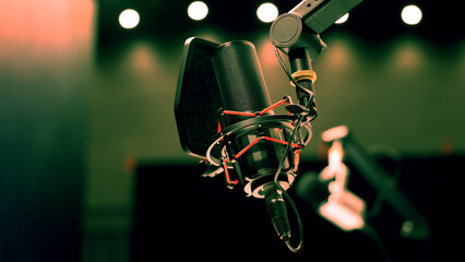 Microphone in studio. Professional studio microphone with a pop filter is suspended boom arm and...
