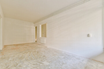 A spacious, undecorated room with plain white walls and a bare floor, ready for interior design or renovation. Ideal for inspiration in minimalist aesthetics.