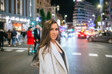 Obraz premium Businesswoman walking in city street at night looking confident