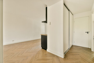 Bright and airy modern interior showcasing a wooden floor and simple aesthetic, highlighting minimalism and functionality in design.