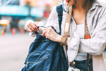 Traveller woman hand open backpack for checking equiment and stuff