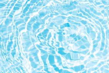 Blue water with ripples on the surface. Defocus blurred transparent blue colored clear calm water surface texture with splashes and bubbles. Water waves with shining pattern texture background.