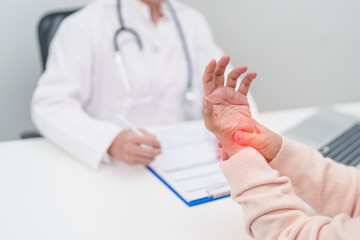 Elderly Patient Woman wrist pain and Consulting doctor. muscle ache from Carpal Tunnel Syndrome, De...