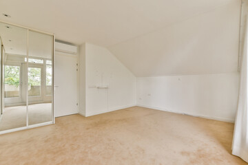 This minimalist room features neutral tones, ample natural light through large windows, and a spacious layout, ideal for a peaceful retreat or creative workspace.