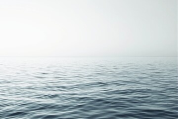 Obraz premium Serene ocean water with gentle ripples under soft light.
