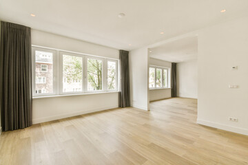 Bright and airy living space featuring large windows, minimalist design, and natural wooden flooring. Ideal for creating a cozy atmosphere in a modern home.