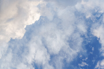 Majestic sunny sky with scattered small clouds