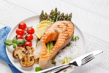 Grilled salmon steak over grilled asparagus, a delicious meal