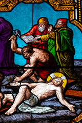 Stained glass (19th century) of The Way of the Cross. Eleventh station: Jesus is nailed to the...