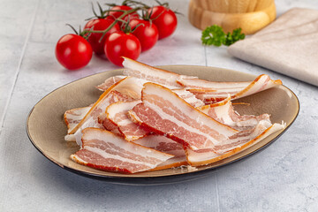 Raw pork tenferloin with bacon