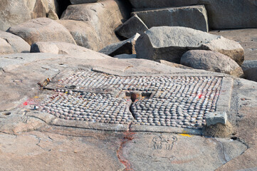 Religious place to worship hindu gods in the boulders of Hampi, ritual with color for Holi...
