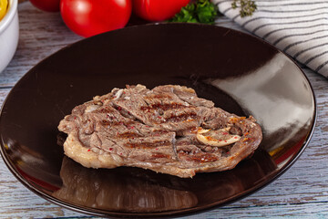Grilled lamb steak with bone