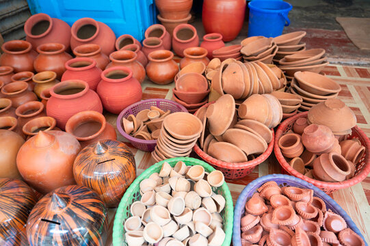 Handmade clay pottery at a market stall in India, handicraft terracotta bowl, jar and vase ceramics