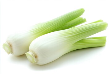 Fresh green leeks arranged on a white background, showcasing their vibrant colors and textures