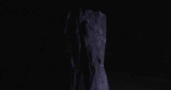A weathered stone catches subtle light at Drombeg Stone Circle, exuding ancient presence and quiet, mystical energy.