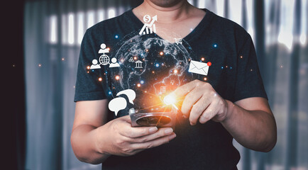 Businessman using smartphone to make online transactions with glowing digital hologram icons and world map symbolizing global communication, technology, big data, search and online marketing.