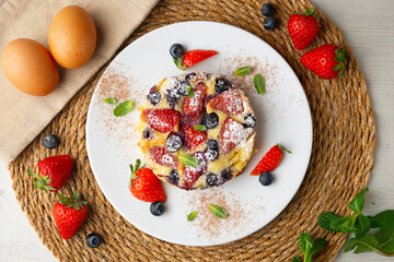 French clafoutis tart with red berries. Top view.