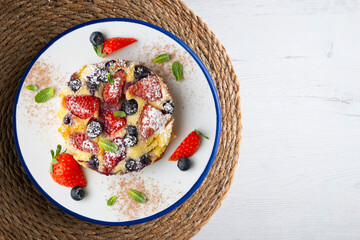 French clafoutis tart with red berries. Top view.