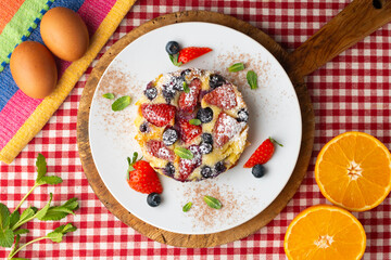 French clafoutis tart with red berries. Top view.