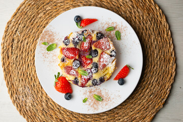 French clafoutis tart with red berries. Top view.
