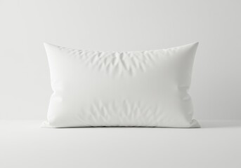 A simple white pillow on a white surface against a white background in a studio setting light