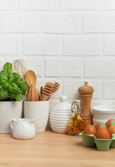 Kitchen utensils, eggs, herbs and spices creating a cozy culinary scene
