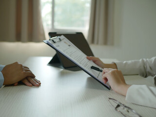 Young businesswoman holds a resume and evaluates it. Views the personal history of job applicants....