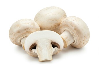 Fototapeta premium A close up shot of several white button mushrooms with one cut in half on a white background plain view
