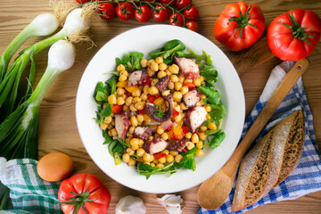 Salpicon de pulpo. Octopus salad with chickpeas, arugula and vegetables. Top view table.