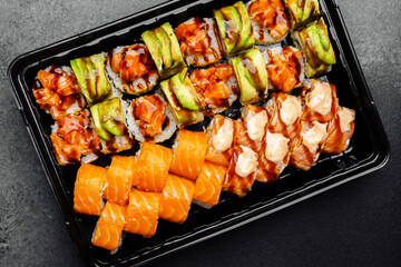 Savory sushi platter featuring assorted rolls and fresh salmon slices