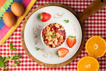 Individual baked strawberry crumble. Top view table.