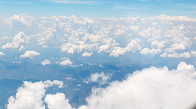 Image of white beautiful clouds above blue sky style of realistic atmospheres, aerial view