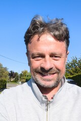 smiling handsome middle aged man cheerful guy making selfie photo in summer day