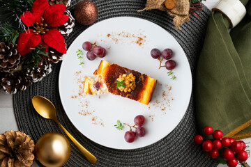 Cheesecake with grapes. Top view table with christmas decorations.