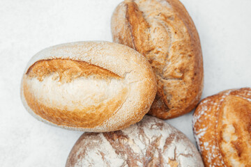 Freshly baked artisan bread loaves in rustic display on neutral background