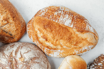 Artisan bread varieties arranged on a clean surface with natural textures