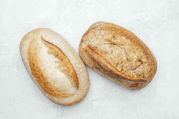 Freshly baked artisan bread loaves on a light marble surface