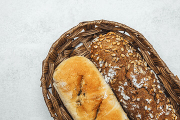 Freshly baked bread assortment in a woven basket on a light surface