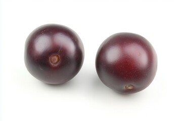 Two ripe purple plums on a white background, showcasing their smooth texture and color