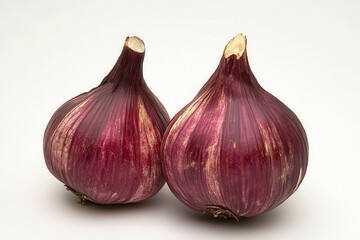 Obraz premium Two vibrant red onions positioned closely against a clean white background, showcasing their texture and color