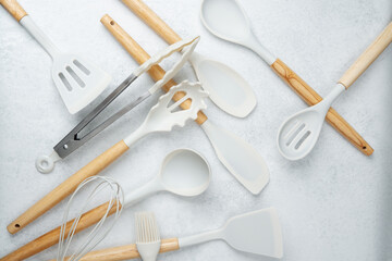 Kitchen utensils and baking tools arranged on a light surface