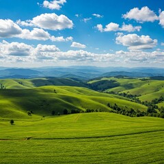 Obraz premium Serene Horizons: A Panoramic View of Lush Green Hills and Blue Skies