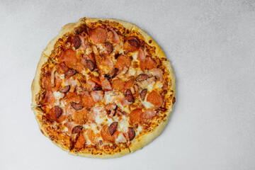 Delicious pepperoni pizza on a light textured surface ready to enjoy
