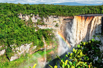 Kaieteur Falls with a rainbow in a rainforest in Guyana