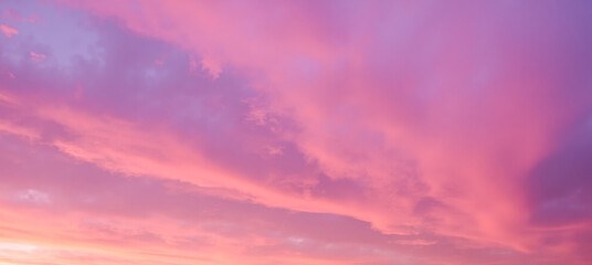 Colorful soft pink and purple sky at sunset with clouds, dreamy romantic atmosphere, abstract natural pastel background perfect for relaxation and inspiration themes